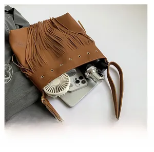 Top view showing large capacity brown leather tote bag with fringe and metal eyelets