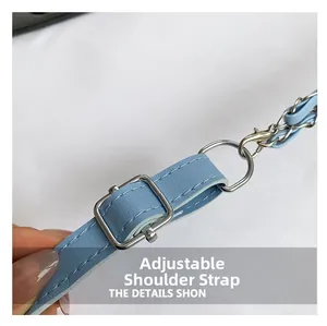 Detail of light blue leather strap with silver adjustable buckle and chain hook