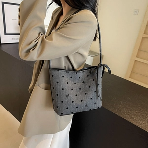Gray bucket shoulder bag with black polka dots and side ribbon bow detail for women