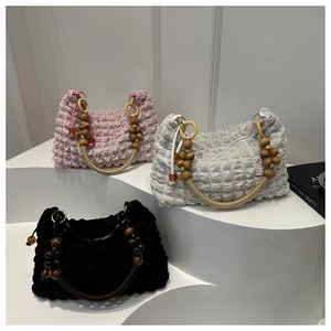 Three pleated bubble bags in pink, grey, and black with wooden bead handle details