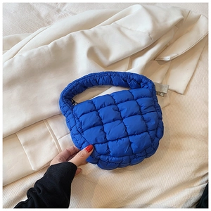 Close-up of Klein Blue quilted cloud bag with padded nylon texture and square pattern