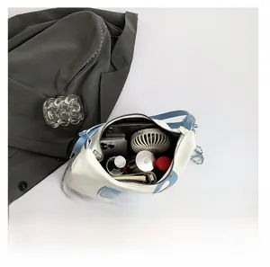 Spacious tote bag interior showing capacity for smartphones, fans and makeup items