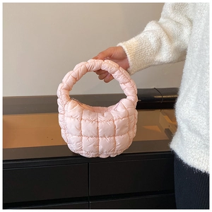 Detailed macro view of light pink quilted bubble cloud bag with soft puffy texture