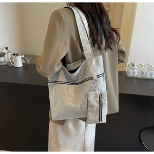 Detail of metallic silver tote bag with textured crinkle finish and matching coin purse