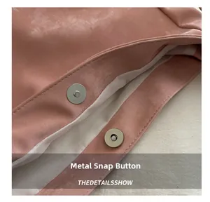 Close-up of pink tote bag showing premium suede texture and magnetic buckle closure
