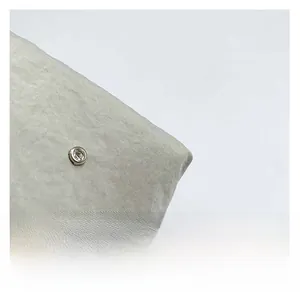 Macro shot of fine twill fabric and silver metal button with sparkling diamond inlay