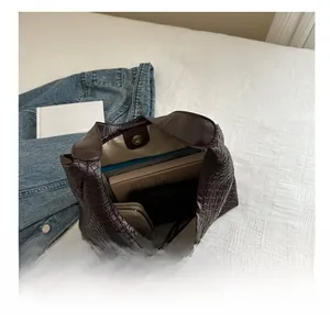 Macro view of interior storage capacity and magnetic snap closure of woven tote bag
