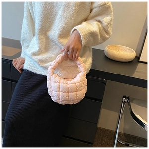 Close-up of soft pink quilted cloud bag with premium puff texture and elegant mini handle