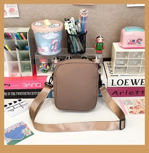 Detailed view of the brown canvas messenger bag with wide adjustable shoulder strap
