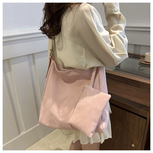 Detailed view of pink faux suede tote bag set with matching small pouch for commuting