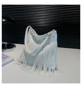 Close-up of white lychee pattern faux leather tote bag with long tassels and gold rivets