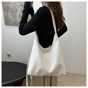 Detailed close-up of white woven texture on a large capacity hobo shoulder tote bag