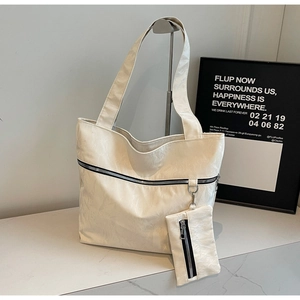 Detail of cream tote bag with wrinkled faux leather texture and detachable coin purse