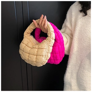 Detail of beige and magenta quilted bubble handbags with soft padded nylon texture