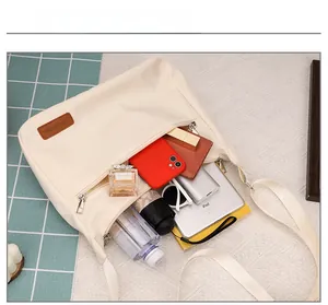 Spacious off-white canvas tote interior showing capacity for tablet, umbrella and phone