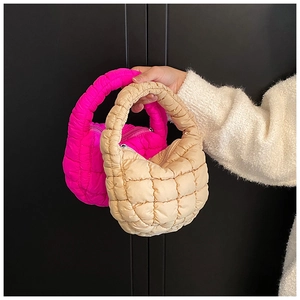 Detail showing fuchsia and beige quilted cloud mini bags with pleated nylon texture