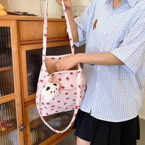 Pink corduroy strawberry tote bag featuring a cute white panda plush charm detail