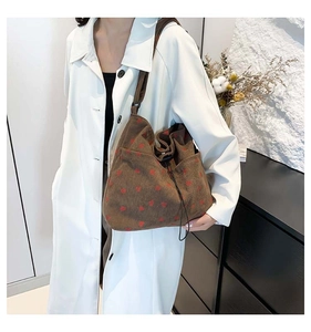 Brown corduroy shoulder bag with red heart patterns and adjustable drawstring closure