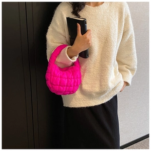 Detailed view of the quilted rose red puff handbag with premium cloud texture