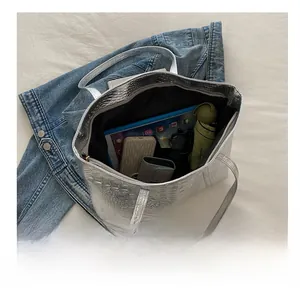 Silver tote bag with crocodile texture showing large capacity for tablet and daily items