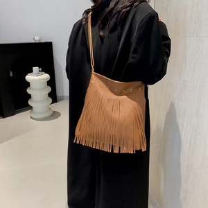 Brown vintage faux leather hobo bag with long fringe tassels and metal eyelets
