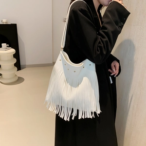White fringe shoulder bag with studs and lychee texture worn with a black suit jacket