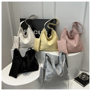 Detailed display of tote bags in five colors with matching small zipper pouches
