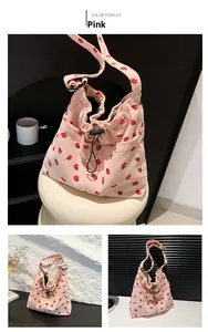 Detailed views of pink corduroy tote bag featuring red strawberry patterns and drawstring