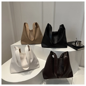 Detail view of four large woven hobo tote bags in khaki, black, white, and coffee colors
