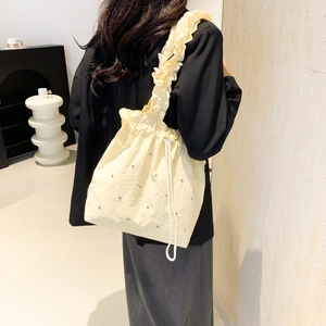 Beige pleated tote bag with silver rivets and ruffle shoulder strap for summer