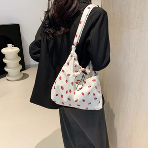 Minimalist white corduroy tote bag with red strawberry print and drawstring closure