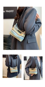 Detailed shot of rainbow woven bag with black leather logo strap for summer vacations