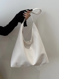 Minimalist white woven leather hobo bag with top handle and spacious interior