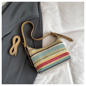 Detail of colorful rainbow woven fabric on shoulder bag with adjustable brown leather strap