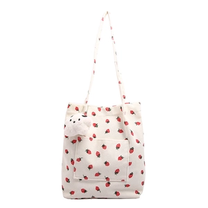 White corduroy tote bag with red strawberry print and cloud plush pendant accessory