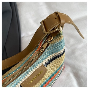 Close-up of rainbow woven texture and brown leather strap with golden metal buckle