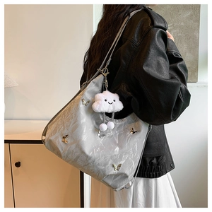 Détail du grand sac cabas gris argenté avec papillon métallique et breloque nuage en peluche