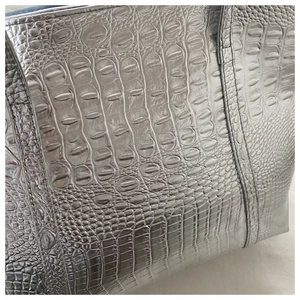 Close-up of silver tote bag with premium crocodile embossed texture and neat stitching