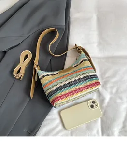 Detailed view of a rainbow woven hobo bag with adjustable brown leather shoulder straps