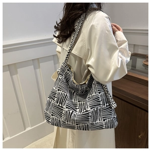 Detailed close-up of black and white geometric knit pattern on a large capacity tote bag