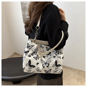 Detail of the butterfly pattern canvas tote bag with metal chain and faux leather strap