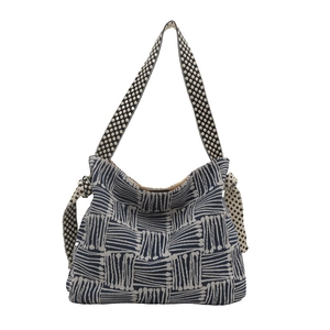 Canvas tote bag with blue geometric pattern and wide polka dot shoulder strap