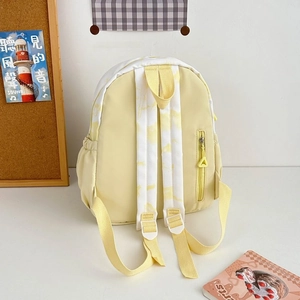 Detail view of water-resistant nylon backpack showing side pocket and tie-dye patterns