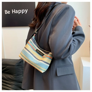 Macro shot of colorful rainbow woven texture and fashion bags leather label on tote