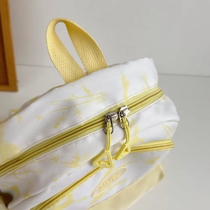 Close-up of waterproof nylon fabric texture and double zipper detail on white backpack
