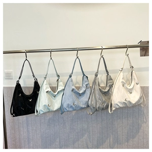 Detail view of large capacity hobo bags with metallic butterfly accents in five colors