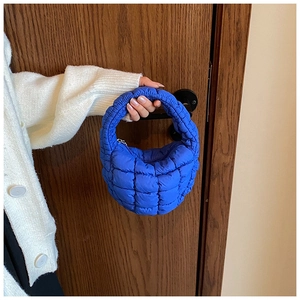 Detail of royal blue quilted cloud bag showing the puffy texture and soft nylon fabric