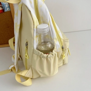 Detailed side view of nylon backpack with water bottle stored in the elastic side pocket