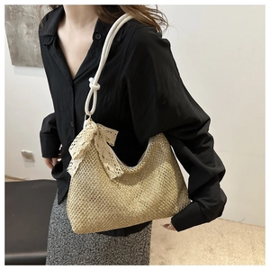 Detailed texture of natural straw weave bag with elegant lace bow and cotton rope handle