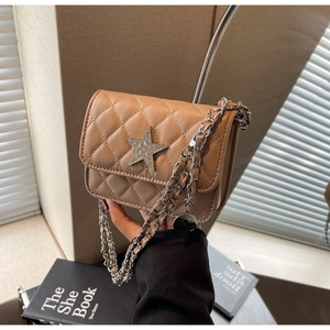 Vue détaillée du sac matelassé beige avec étoile en strass et bandoulière chaîne